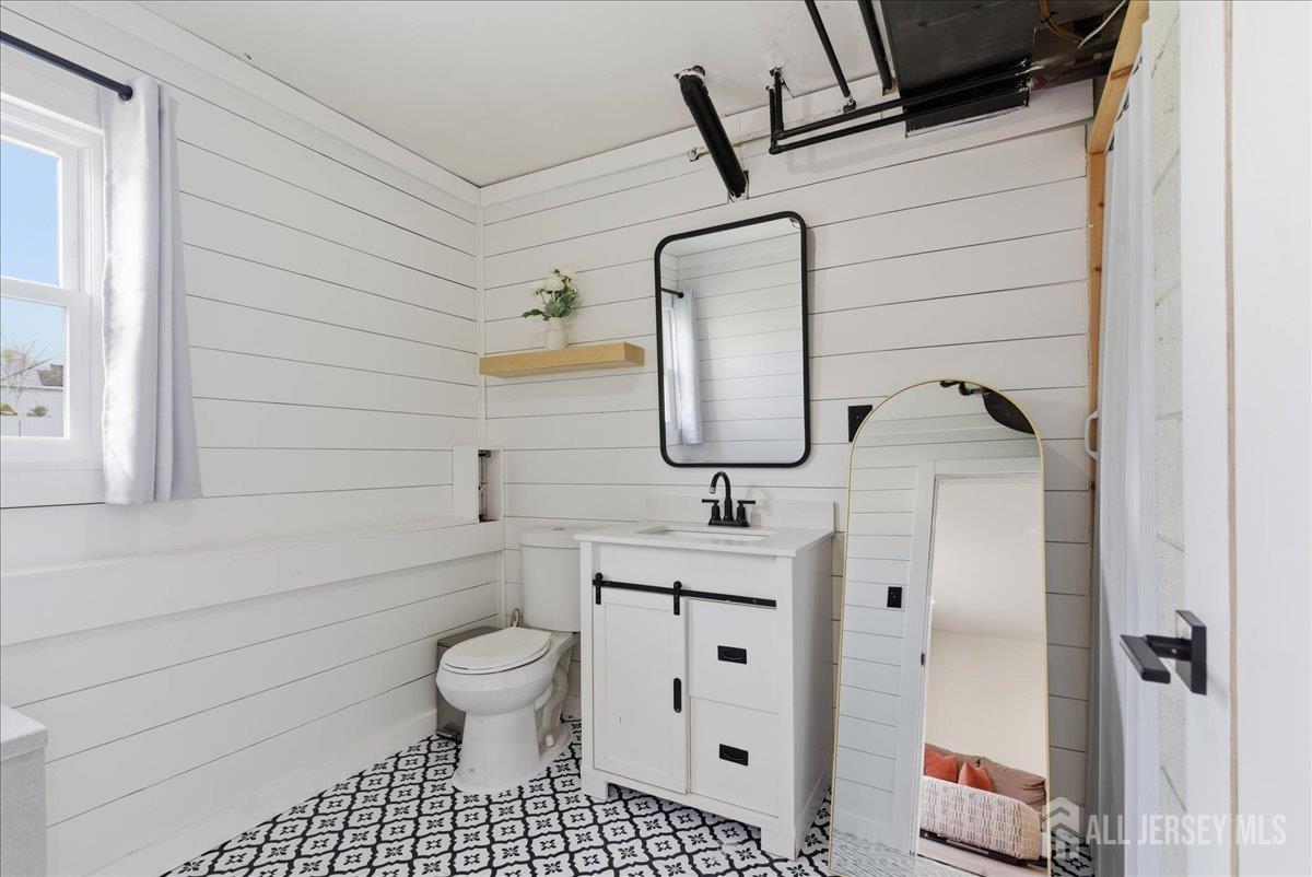 83 Garfield Avenue Colonia, NJ 07067 - Photo 32 of 45 a bathroom with a toilet sink and mirror