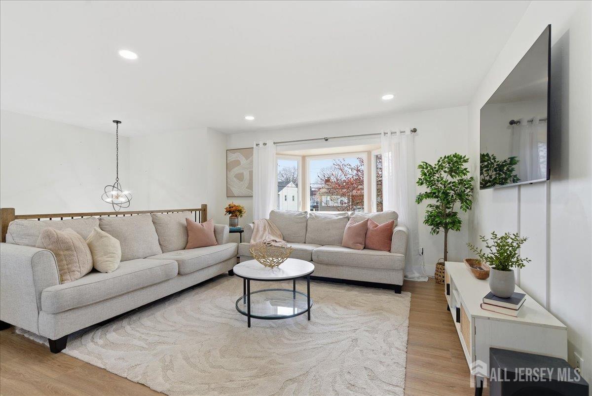 83 Garfield Avenue Colonia, NJ 07067 - Photo 10 of 45 a living room with furniture and a potted plant