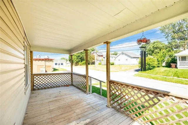 a view of a porch with wooden floor and iron stairs