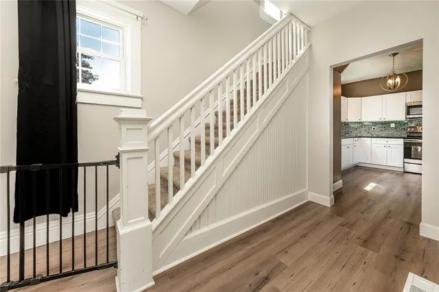 a view of entryway with wooden floor and front door
