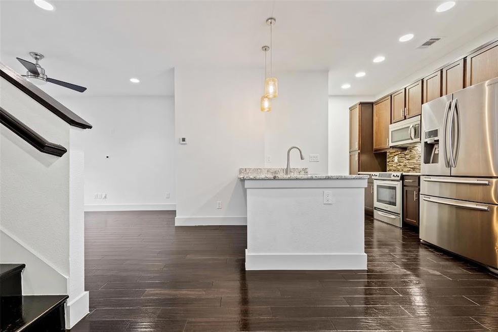5924 Hudson Street, Unit F Dallas, TX 75206 - Photo 2 of 25 a view of kitchen with stainless steel appliances refrigerator stove microwave and cabinets