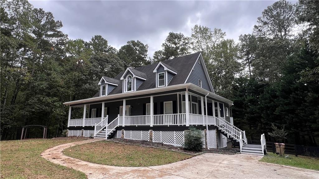 8434 Majors Road Cumming, GA 30041 - Photo 4 of 23 a front view of a house with a garden