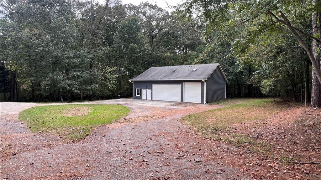 8434 Majors Road Cumming, GA 30041 - Photo 5 of 23 a view of a house with backyard and trees