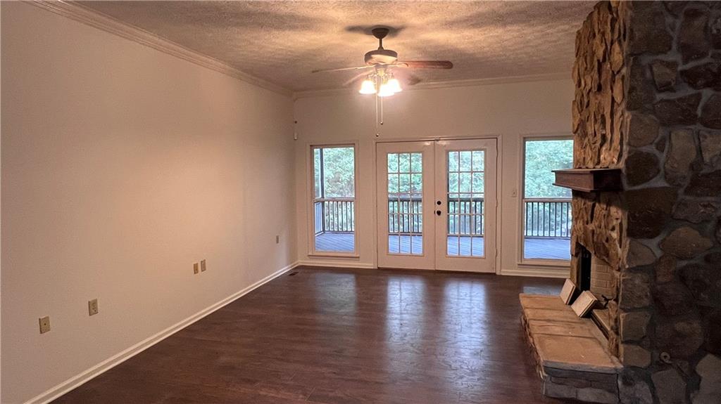 8434 Majors Road Cumming, GA 30041 - Photo 6 of 23 a view of an empty room with wooden floor and a window
