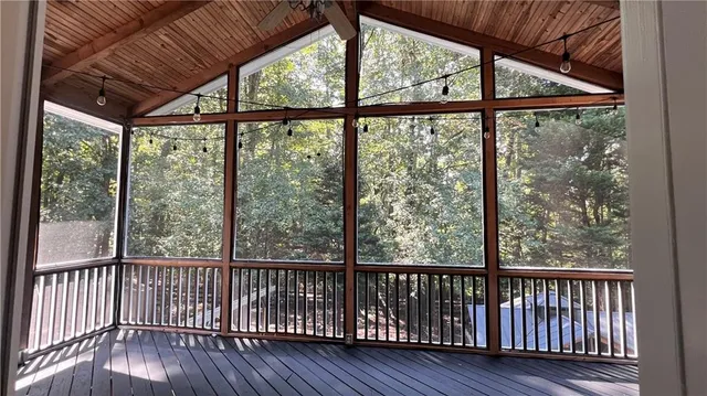 a view of a wooden deck with a yard