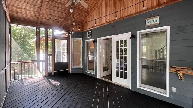 a view of a porch with wooden floor and iron stairs