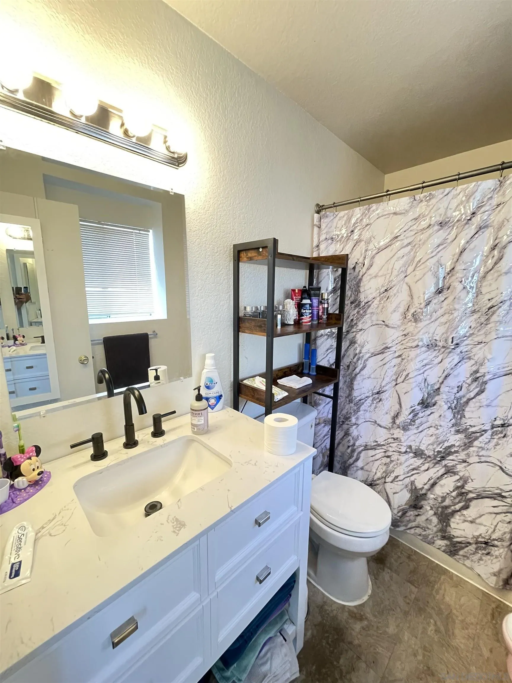 39490 Long Ridge Drive Temecula, CA 92591 - Photo 12 of 18 a bathroom with a sink mirror vanity and toilet