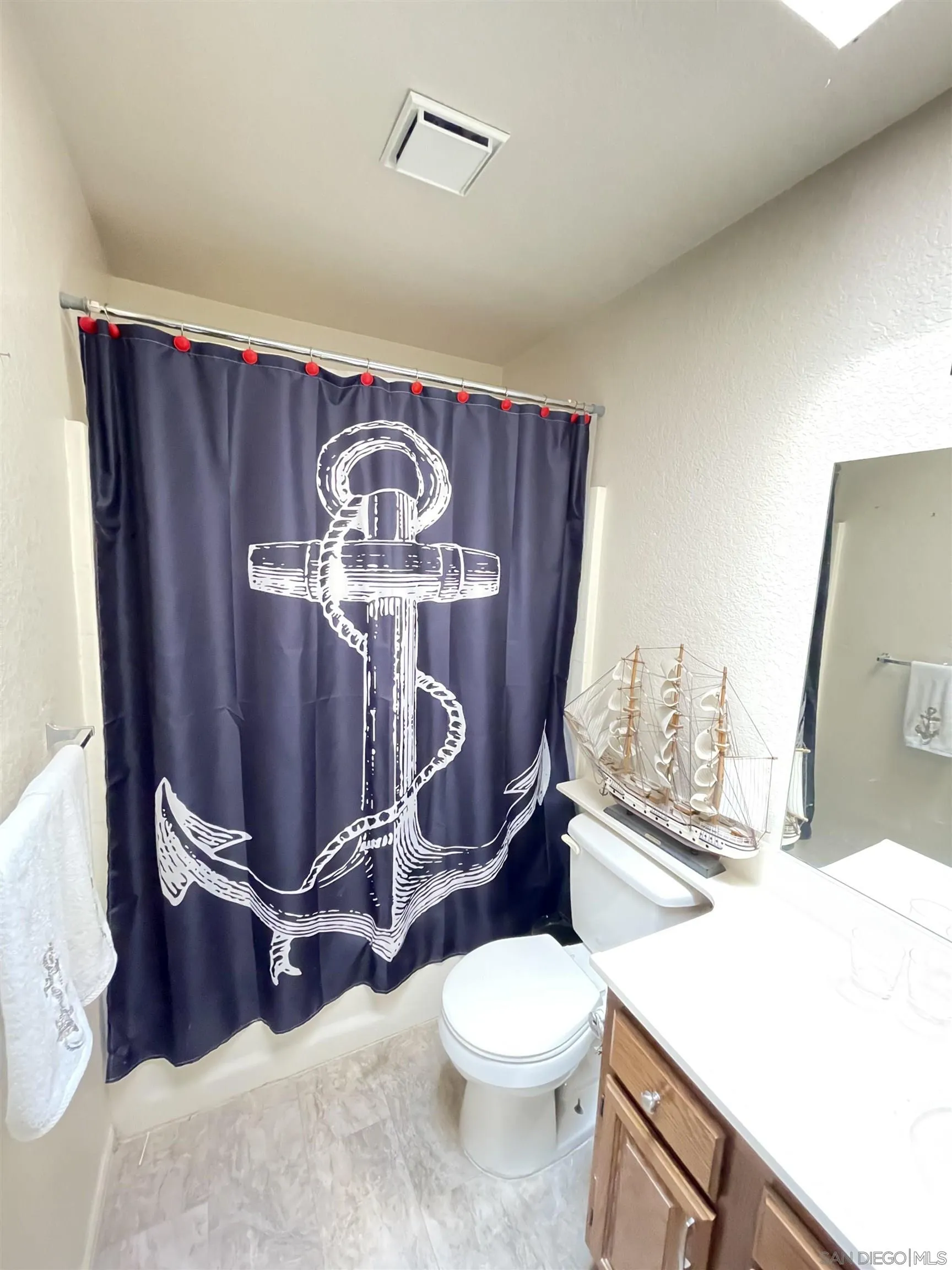 39490 Long Ridge Drive Temecula, CA 92591 - Photo 16 of 18 a bathroom with a toilet mirror and vanity