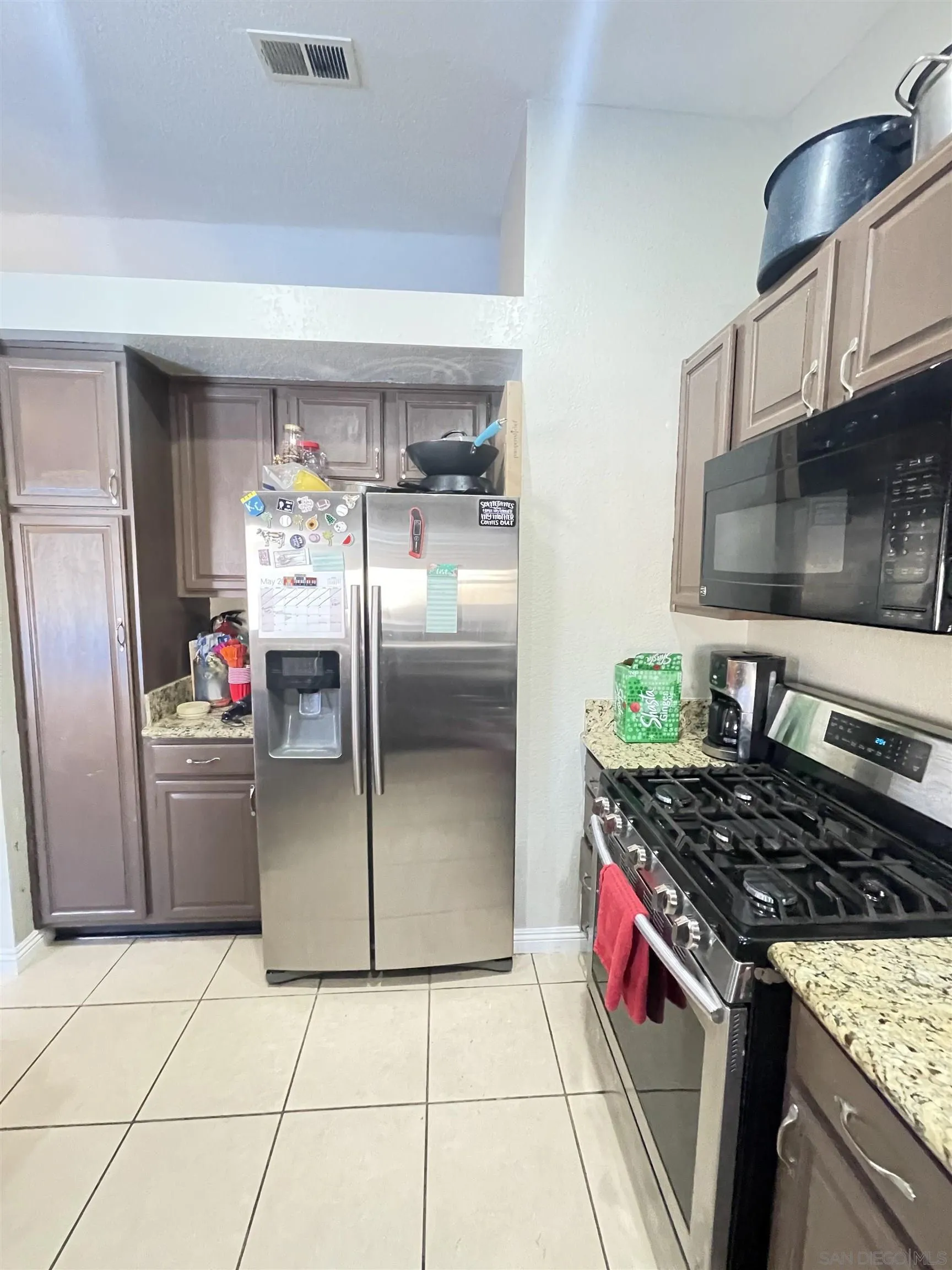 39490 Long Ridge Drive Temecula, CA 92591 - Photo 8 of 18 a kitchen with stainless steel appliances granite countertop a sink and a refrigerator