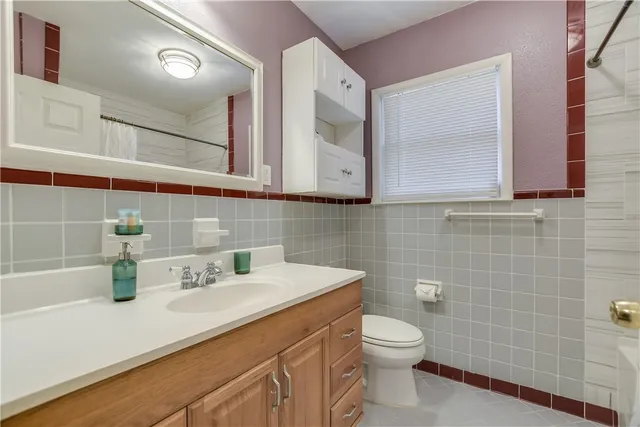 a bathroom with a sink a toilet and mirror