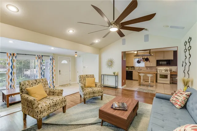 a living room with furniture and wooden floor
