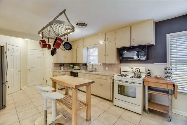 a kitchen with a sink cabinets and window