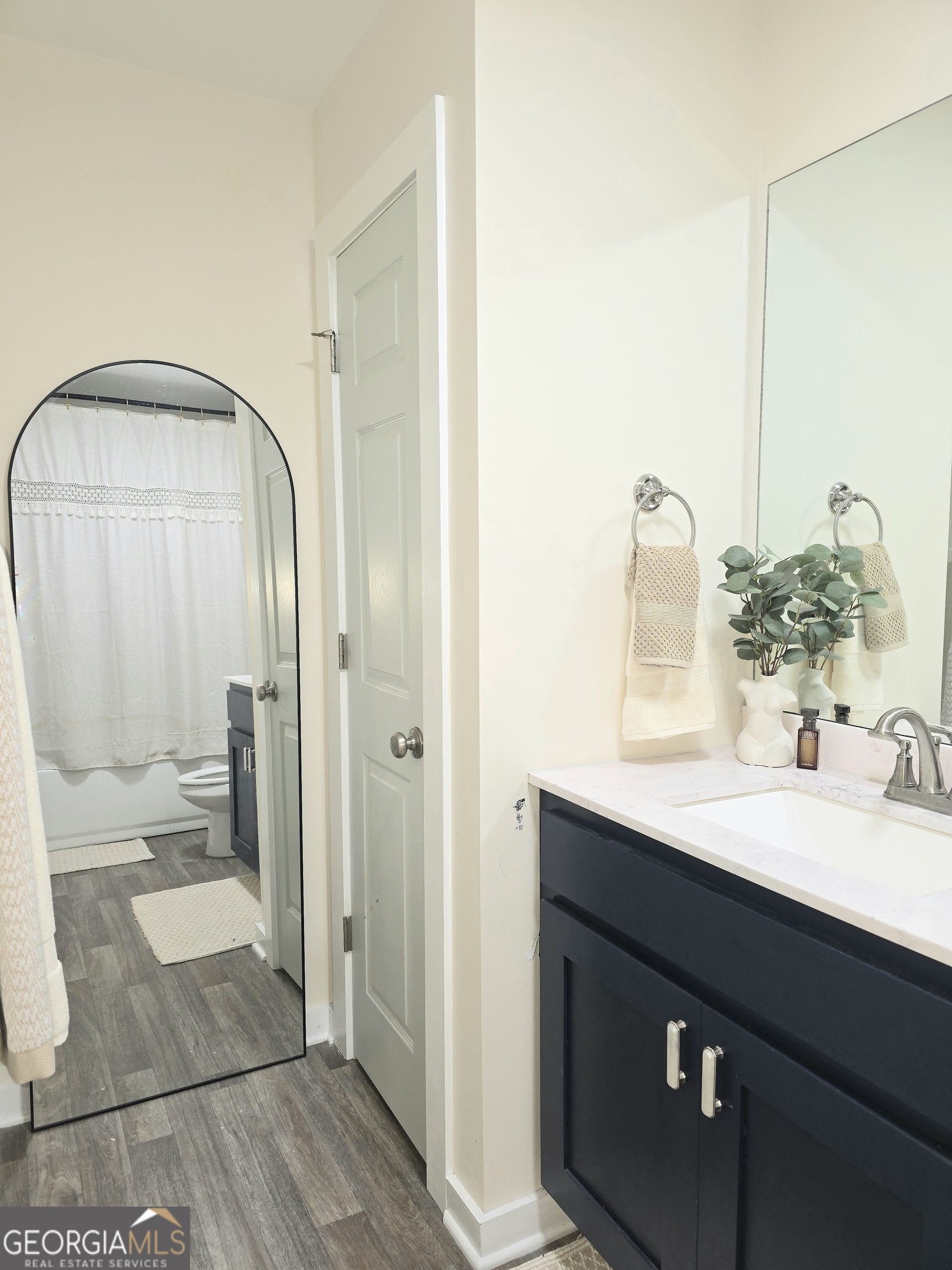 3060 Eatonton Road Madison, GA 30650 - Photo 52 of 65 a bathroom with a double vanity sink and a mirror