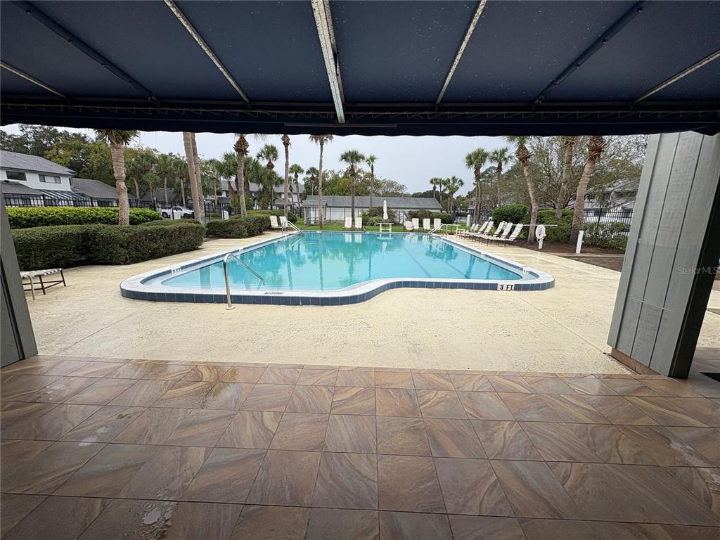 9360 Craven Road, Unit 1104 Jacksonville, FL 32257 - Photo 22 of 25 a view of a swimming pool with a porch