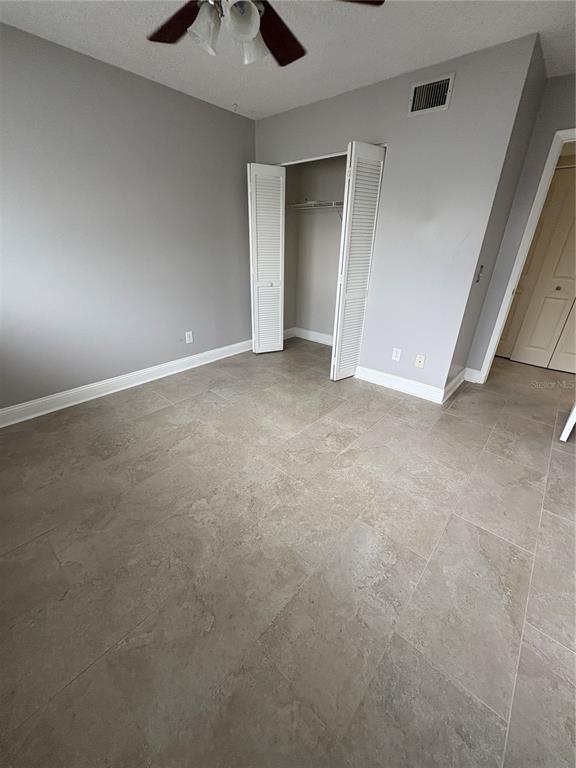 9360 Craven Road, Unit 1104 Jacksonville, FL 32257 - Photo 6 of 25 a view of an empty room and chandelier fan