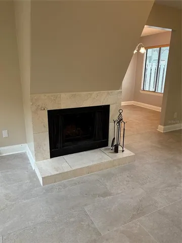 a living room with a fireplace and a large window
