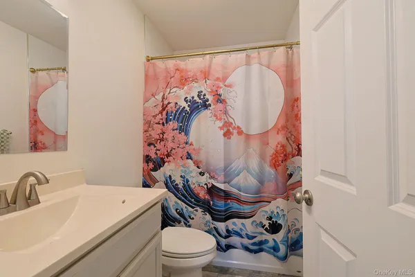 a white toilet sitting next to a bathroom sink