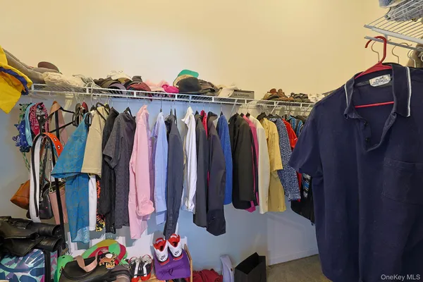 a living room with lots of storage and utility room