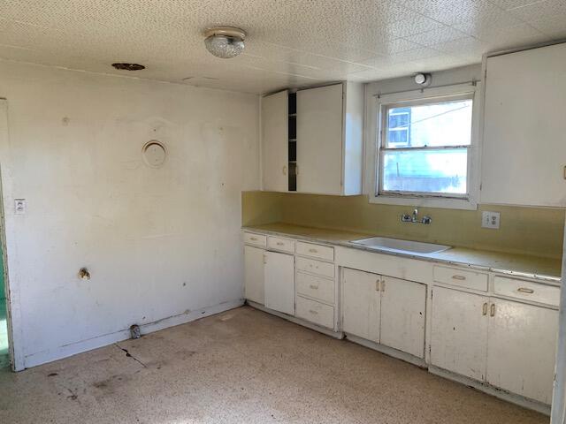 4040 Cedar Street Cutten, CA 95503 - Photo 4 of 21 a room with granite countertop white cabinets and a sink