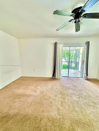 a view of empty room with ceiling fan