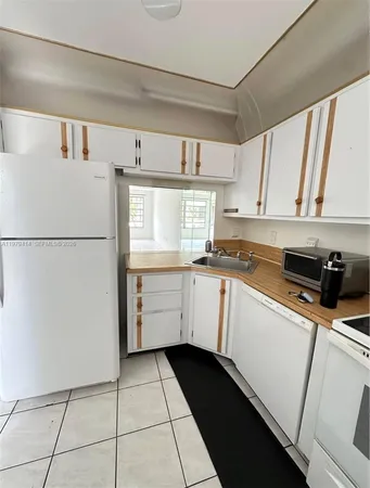 a kitchen with a refrigerator a stove a microwave and cabinets