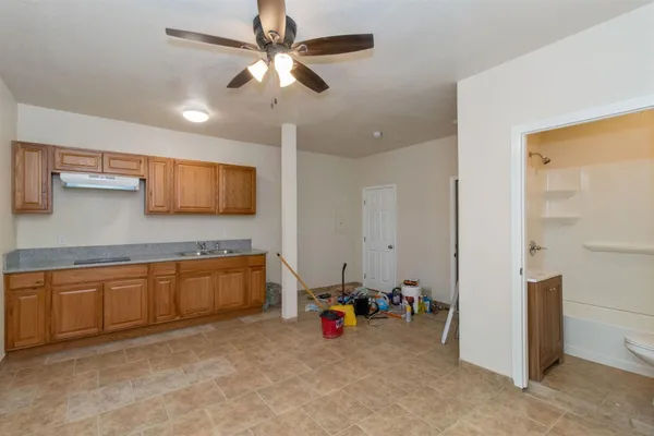 a view of a kitchen with a sink and cabinets