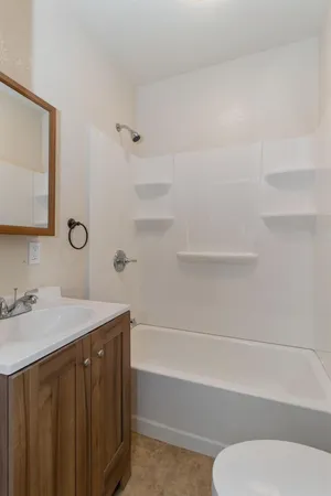 a view of a kitchen with sink and wooden cabinets