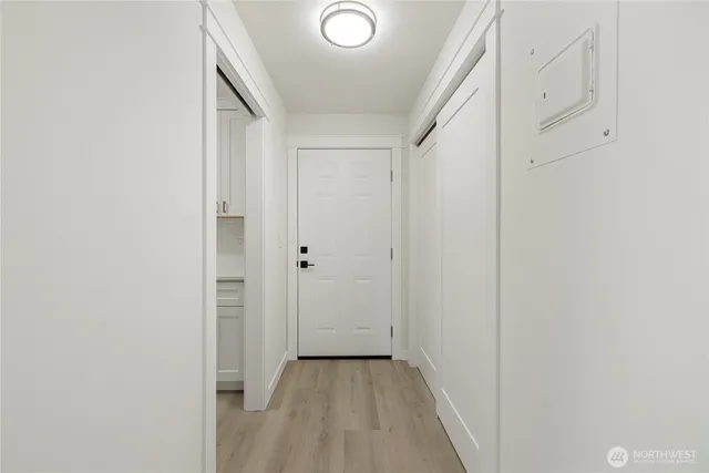 a view of a hallway with wooden floor
