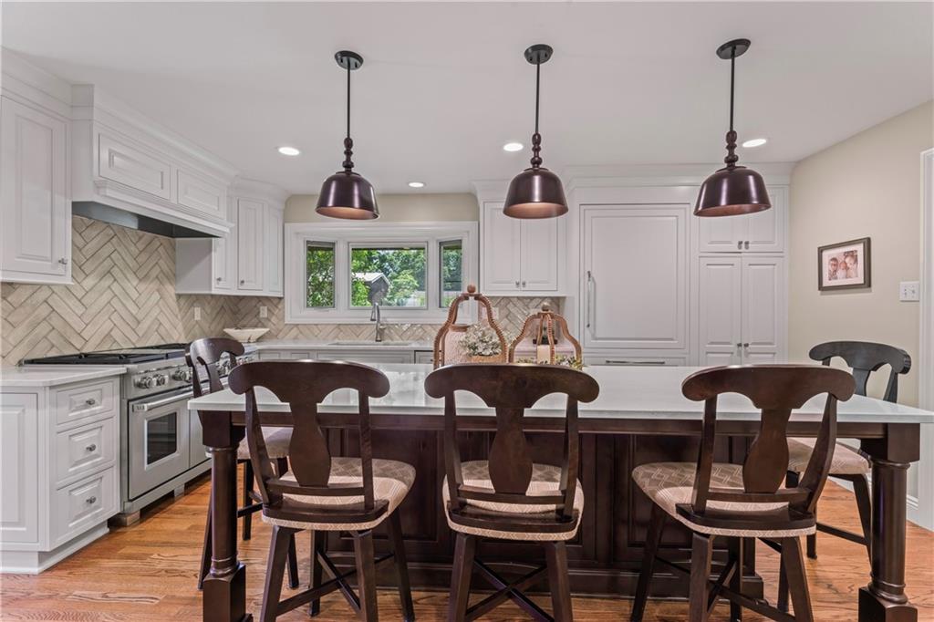 102 Forest Drive Beaver, PA 15009 - Photo 16 of 32 a kitchen with stainless steel appliances a dining table chairs and white cabinets