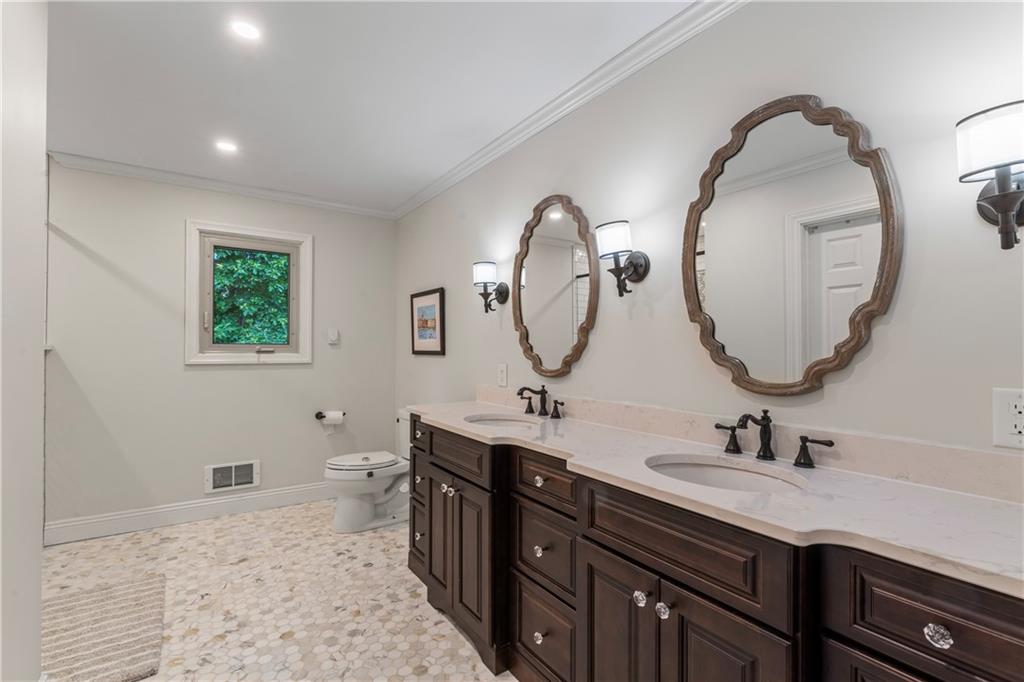 102 Forest Drive Beaver, PA 15009 - Photo 22 of 32 a bathroom with a double vanity sink and a mirror