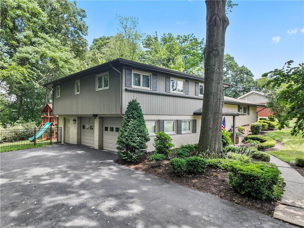 102 Forest Drive Beaver, PA 15009 - Photo 3 of 32 a front view of a house with a garden