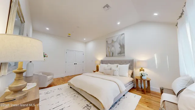 a bedroom with a bed and a lamp