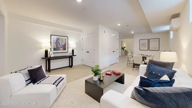 a living room with furniture and a painting on the wall