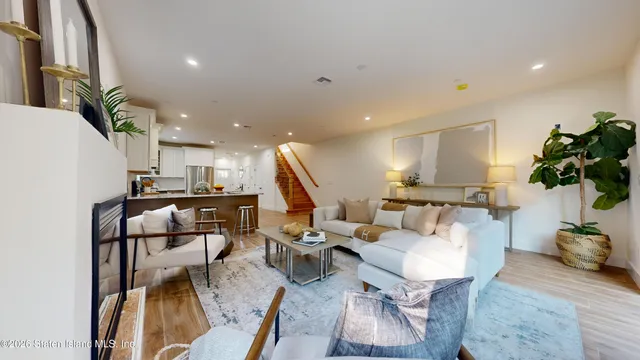 a living room with furniture kitchen view and a table