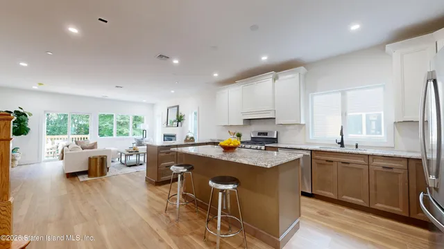 a kitchen with a table chairs sink and cabinets