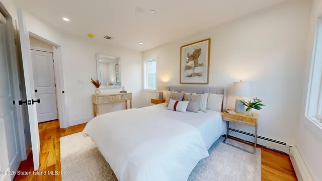 a spacious bedroom with a bed and a couch