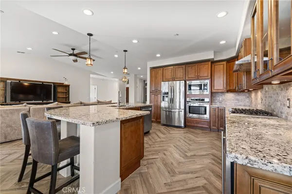 a kitchen with granite countertop a sink and a stove
