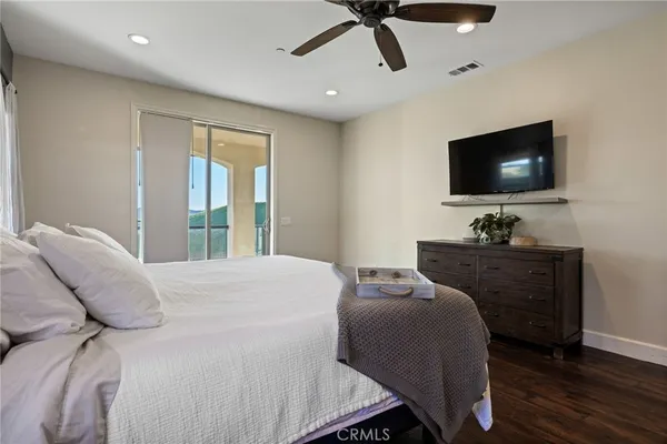 a bedroom with a balcony and large window