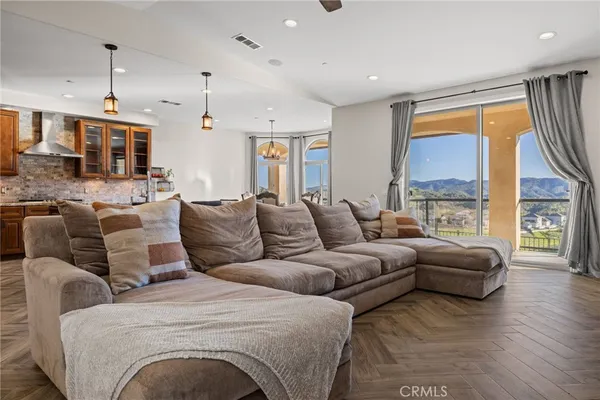 a kitchen with a dining table chairs sink and cabinets