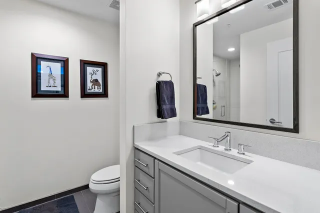 a dining room with stainless steel appliances wooden floor dining table and chairs