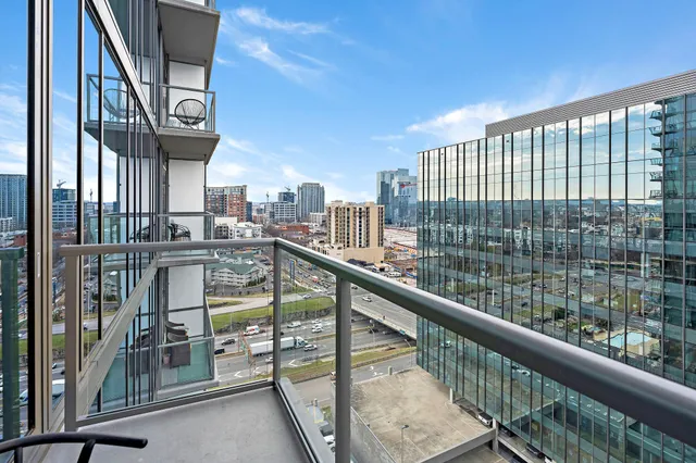 a dining room with furniture a chandelier and a flat screen tv