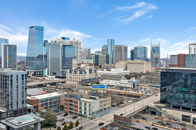 a living room with furniture and large windows