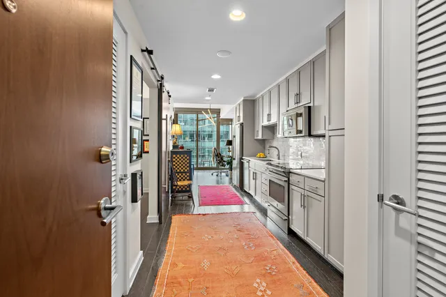 a kitchen with stainless steel appliances granite countertop a stove a sink and a refrigerator