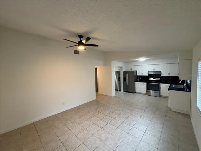 a view of a kitchen with a sink and a refrigerator