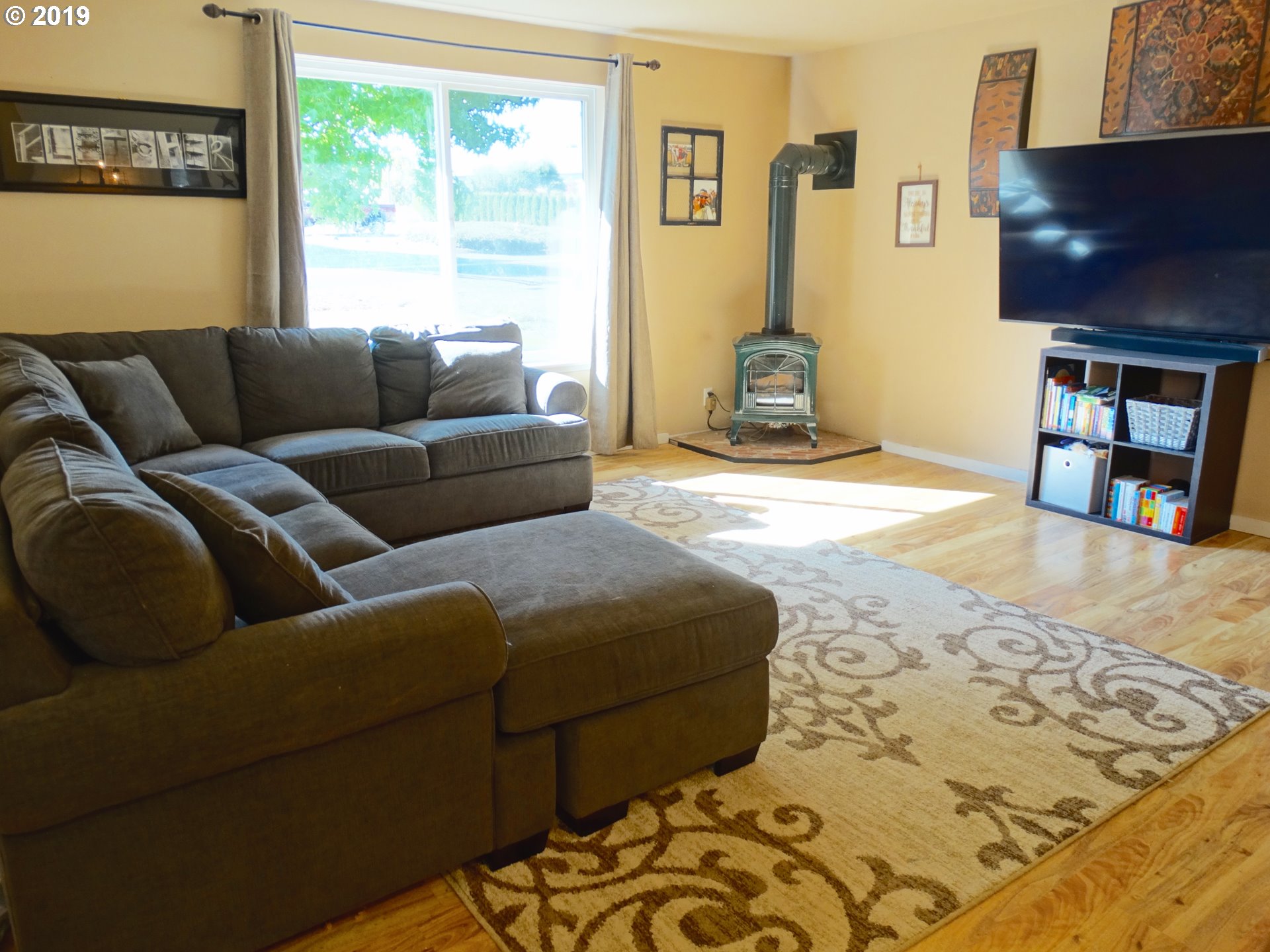 4100 Southwest Dilley Road Forest Grove, OR 97116 - Photo 3 of 27 a living room with a couch and a flat screen tv