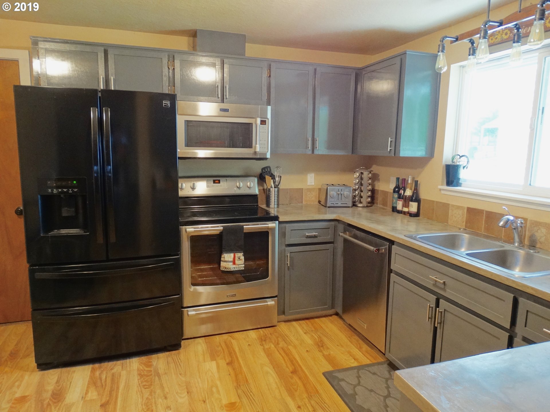 4100 Southwest Dilley Road Forest Grove, OR 97116 - Photo 7 of 27 a kitchen with a refrigerator and a sink