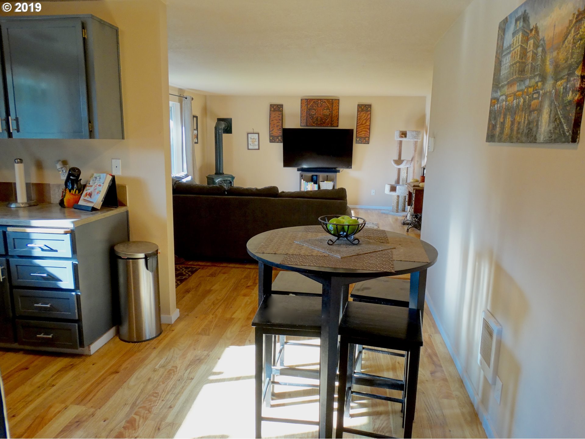 4100 Southwest Dilley Road Forest Grove, OR 97116 - Photo 10 of 27 a kitchen with stainless steel appliances a dining table chairs and a refrigerator