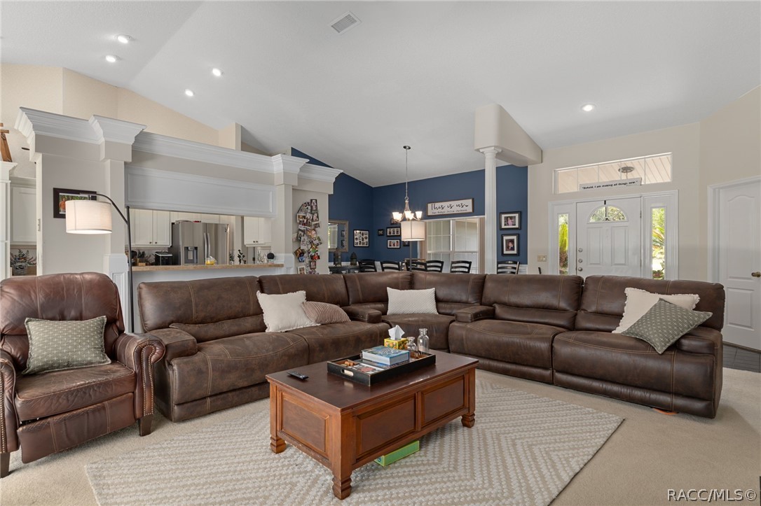 2460 West Pine Ridge Boulevard Beverly Hills, FL 34465 - Photo 25 of 47 a living room with furniture a rug and a couch