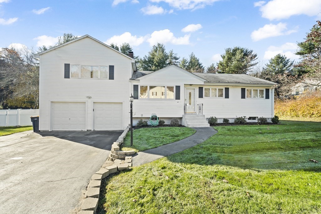 45 Lyndon Road Sharon, MA 02067 - Photo 22 of 31 a front view of a house with a yard and garage