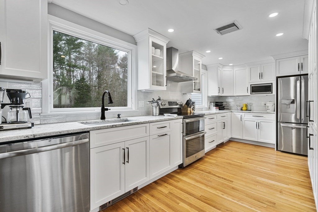 45 Lyndon Road Sharon, MA 02067 - Photo 5 of 31 a kitchen with white cabinets and white appliances